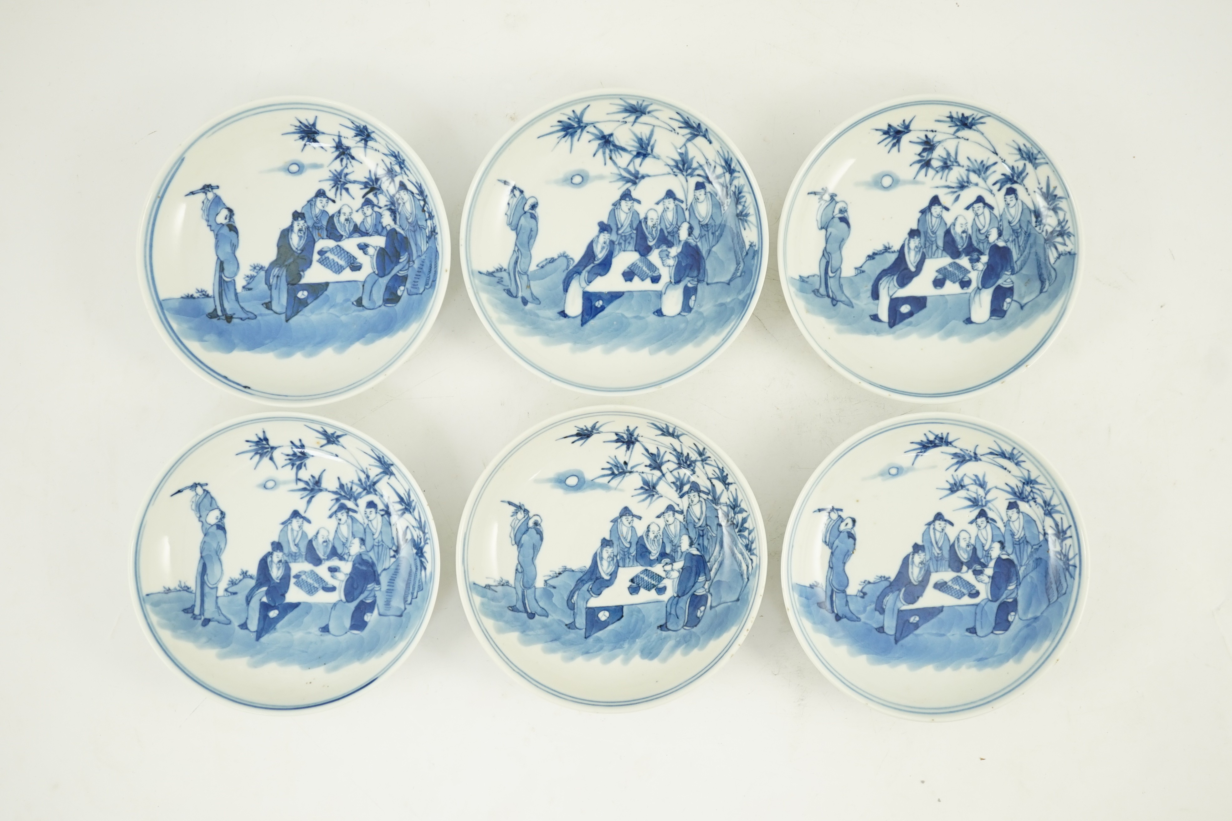 A set of six Chinese ‘Seven Sages of the Bamboo Grove’ saucer dishes, Kangxi marks but late 19th century, 12.3cm diameter